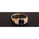 AN 18CT RING SET WITH SAPPHIRE AND DIAMONDS Marked '18' (size U). (5461/BG1038815/1)