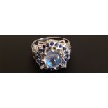 A 14CT GOLD DRESS RING SET WITH A MOONSTONE AND SAPPHIRES With four diamonds to each corner and