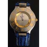 A LADIES' CARTIER "MUST DE CARTIER 21" WRIST WATCH The stainless steel and gilt case on blue leather