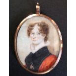 AN 18TH CENTURY OVAL PORTRAIT MINIATURE ON IVORY A lady wearing a lace collar and a blue and red