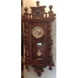 A 19TH CENTURY AUSTRIAN WALNUT VIENNA WALL CLOCK Having a white dial, Roman numerals, turned