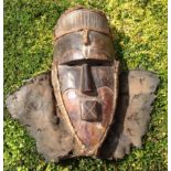 A CARVED AFRICAN TRIBAL ART SONGYE WOODEN MASK Having carved eyebrows and a protruding square mouth,