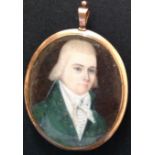AN 18TH CENTURY NAIVE SCHOOL OVAL PORTRAIT MINIATURE Of a gentleman wearing a green jacket, the