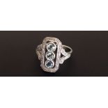 A 9CT GOLD CARTOUCHE FORM DRESS RING SET WITH AQUAMARINES AND DIAMONDS Marked '375' (size Q). (
