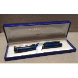 A WATERMAN'S OF PARIS FOUNTAIN PEN SET Having a blue ground with black binding, together with a