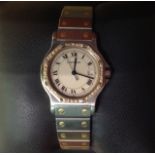 A CARTIER 'SANTOS' MID-SIZE STAINLESS STEEL AND GOLD WRIST WATCH With Roman numeral chapter ring,