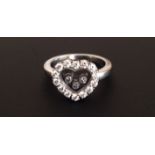 CHOPARD, HAPPY DIAMONDS COLLECTION, AN 18CT WHITE GOLD HEART FORM  RING With three diamonds within