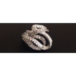 AN 18CT GOLD AND DIAMOND ENCRUSTED SWIRL COCKTAIL RING Marked '750' (size M). Condition: good, one