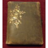 A LATE VICTORIAN LEATHER BOUND PHOTO ALBUM With large brass clasp and embossed design of flowers and