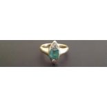 AN 18CT GOLD, EMERALD AND DIAMOND SET RING  The classically cut emerald set between rose cut