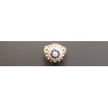 AN 18CT GOLD, DIAMOND AND SAPPHIRE CLUSTER DRESS RING  The central diamond in a raised prong setting