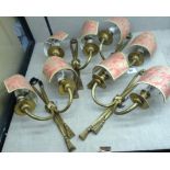 A SET OF FOUR EARLY 20TH CENTURY FRENCH GILT METAL WALL SCONCES With electric light fittings, each