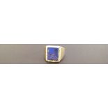 AN 18CT GOLD AND LAPIS LAZULI SET SIGNET RING  The broad yellow gold shank, having a lapis