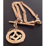 AN ANTIQUE 9CT GOLD ALBERT CHAIN  Hung with a Masonic medallion. (chain 40cm, medallion 2.5cm x 2.