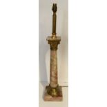 AN EARLY 20TH CENTURY GILT METAL AND ONYX TABLE LAMP With Corinthian capitol above a turned column