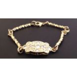 AN 18CT TWO COLOUR GOLD BRACELET With central diamond set panel, the oval shaped yellow gold