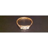 A HALLMARKED 22CT GOLD AND DIAMOND THREE STONE RING The central brilliant cut diamond, with a