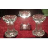 WATERFORD, A PAIR OF CRYSTAL GLASS CANDLESTICKS Having a stepped central column, with flutes and