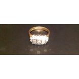 A HALLMARKED 18CT GOLD AND DIAMOND SET RING  The three central slightly graduated square cut,