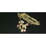 A 9CT GOLD, RUBY AND DIAMOND SET PENDANT  In the form of a flowering branch, having three