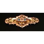 AN EDWARDIAN HALLMARKED 9CT GOLD, TURQUOISE AND DIAMOND BROOCH The flat plaque having raised scrolls