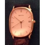 ZENITH, A 9CT GOLD SLIM LINE GENTLEMEN'S WRISTWATCH Having an oval white face, calendar window and