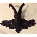 A 19TH CENTURY GERMAN BLACK FOREST WOOD CARVING Of a goats head, with two curved horns and
