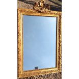 A LATE VICTORIAN GILT FRAMED MIRROR Crested with a cartouche above a silvered plate. (h 115cm x w