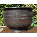 A LARGE 18TH CENTURY CHINESE BRONZE TWIN HANDLED CENSER Having wide bands cast with symbols,