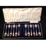 A SET OF TWELVE EARLY 20TH CENTURY HALLMARKED SILVER TEASPOONS AND SUGAR TONGS Each having a