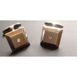 A PAIR OF HALLMARKED 9CT WHITE GOLD AND DIAMOND CUFFLINKS Having facet plain square fronts, with a