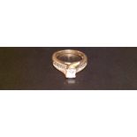 A 14CT GOLD AND DIAMOND SOLITAIRE RING The central Princess cut diamond claw set above a