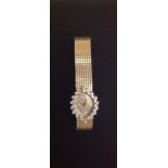 HAMILTON, A 14CT GOLD LADIES' WRISTWATCH The marquise shaped face surrounded by brilliant round