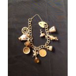 A HALLMARKED 9CT GOLD CHARM BRACELET  Hung with ten charms, Including an 1899 half Sovereign, all