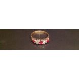 AN EARLY 20TH CENTURY 18CT GOLD, RUBY AND DIAMOND FIVE STONE RING The three round cut rubies,