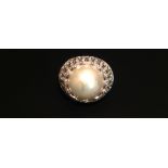 VERSACE, AN 18CT WHITE GOLD, MABÈ PEARL AND DIAMOND DRESS RING The central pearl set on a wide band,