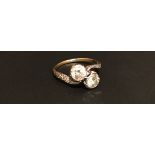 A MID 20TH CENTURY HIGH CARAT GOLD AND DIAMOND TWIST RING The two brilliant cut diamonds claw set in