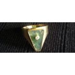 AN UNUSUAL AND STYLISH 18CT GOLD, MOSS AGATE AND DIAMOND RING  The wide gold shank enclosing a