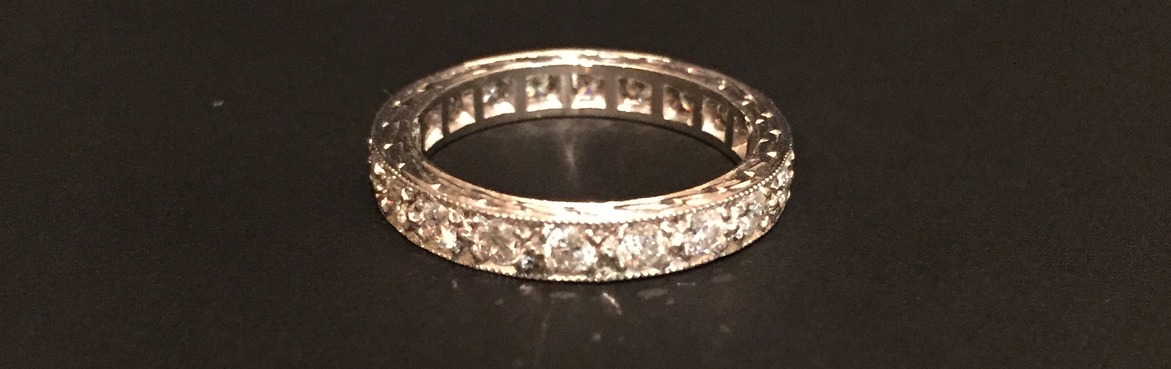 A HALLMARKED 18CT WHITE GOLD AND DIAMOND FULL ETERNITY RING The continuous band of small brilliant