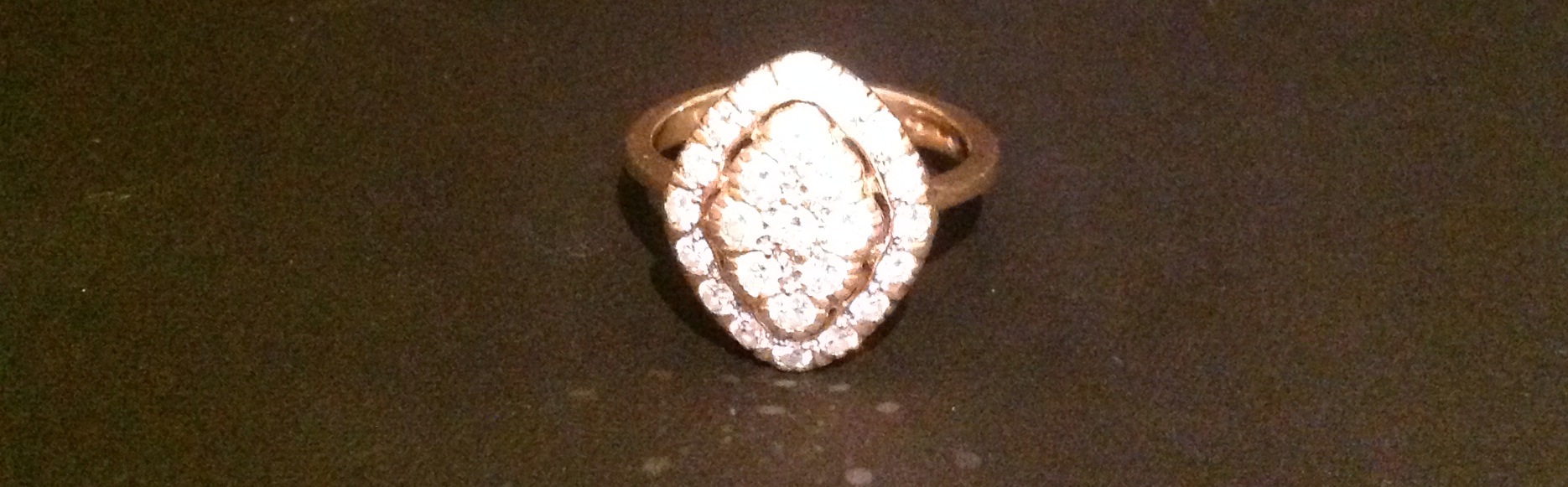 A HALLMARKED 9CT GOLD AND DIAMOND DRESS RING The diamond shaped bezel pavé set, with nine round