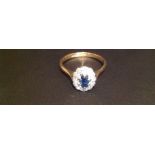 AN 18CT GOLD, SAPPHIRE AND DIAMOND SET RING The oval sapphire within an illusion set diamond border,