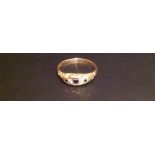 A HALLMARKED 18CT GOLD, SAPPHIRE AND DIAMOND RING Having a graduated line of three sapphires and two