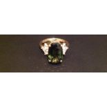 A HALLMARKED 18CT GOLD, TOURMALINE AND DIAMOND DRESS RING The central large oval cut claw set
