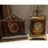 A 19TH CENTURY FRENCH BRASS MANTEL CLOCK Mounted with an urn above an enamelled dial and columns,