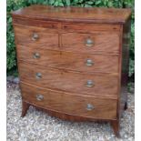 A GEORGIAN MAHOGANY BOW FRONTED CHEST OF DRAWERS Having an arrangement of two secret drawers above