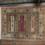 A MIDDLE EASTERN PRAYER RUG Woven with three Mosques, within five running borders. (120cm x 92cm)