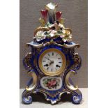 A 19TH CENTURY FRENCH PORCELAIN MANTEL CLOCK Having Rococo shaped body, royal blue ground and gilded