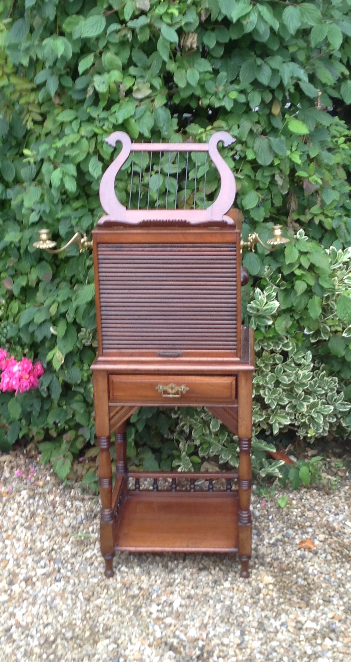 A LATE 19TH CENTURY MAHOGANY MUSIC CABINET The lyre form sheet stand above a fitted tambour front