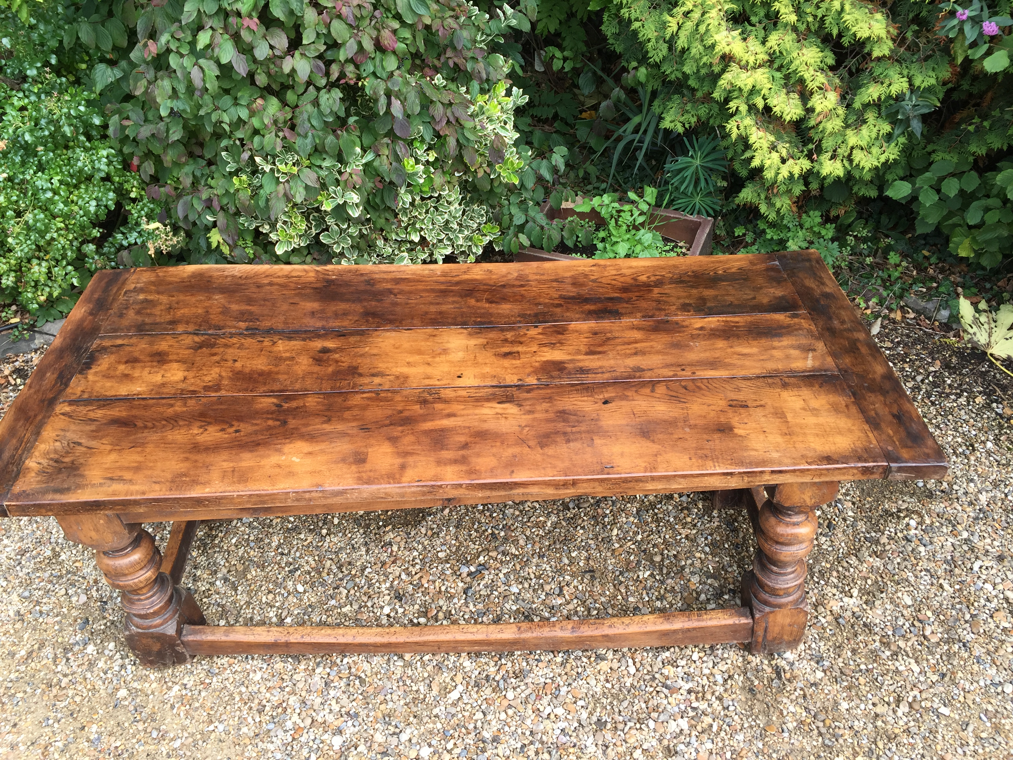 A 17TH CENTURY DESIGN OAK TABLE With a three plank top, raised on heavy turned square legs, joined - Image 2 of 2