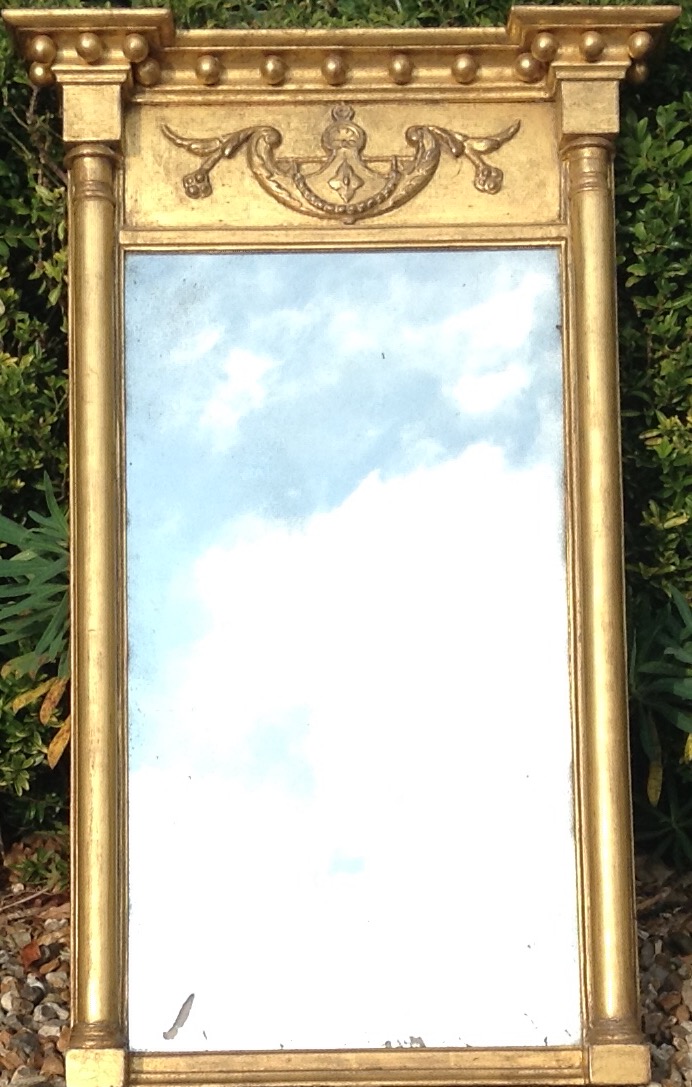 A REGENCY GILT WOOD PIER GLASS MIRROR Classical style with cylindrical side columns and winged